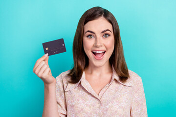 Naklejka premium Photo of cheerful impressed lady wear pink shirt showing bank card open mouth isolated turquoise color background