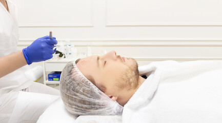 young man in the doctor's office for cosmetic procedures ,dermatologist offices,laser technology.