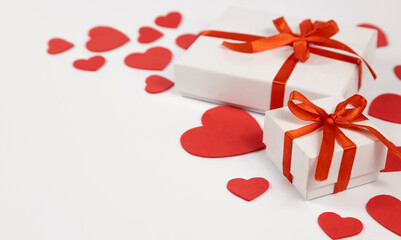 Gift box on the background of red hearts on a white background, with space for text. Postcard. banner