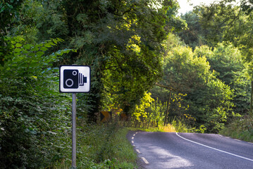 vertical traffic signage, informative, indicating a stretch of road where there is a speed limit controlled by radar, road safety, traffic penalties for speeding. traffic accidents.