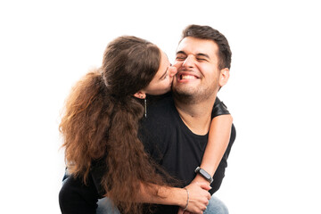 Female model kissing man boyfriend on cheek as couple concept
