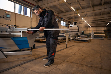 Fototapeta premium Man cutting wood in the workhouse, hard working