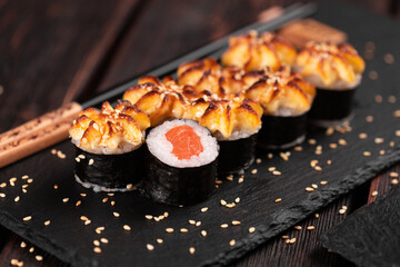 Japanese hot maki roll sushi with salmon - asian food concept