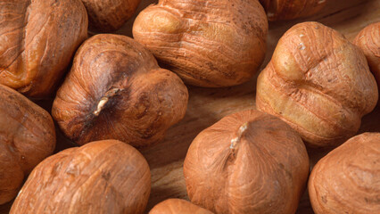 Heap peeled hazelnuts macro. Nuts in wooden plate
