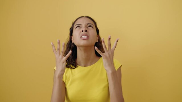 Young african american woman screaming over isolated yellow background