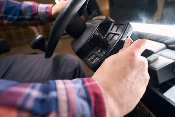 Close-up photo of loader driving car at work