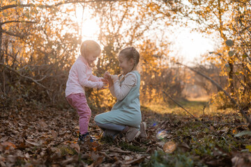 children walk, play, socialize and have fun in the autumn park on a warm sunny day, lifestyle. educational walks, acquaintance with wildlife. High quality photo