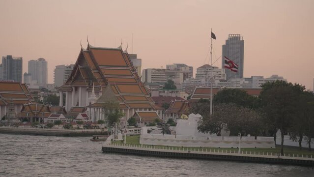 Wat Kalayanamit Woramahawihan Buddhist Temple and Chao Phraya River in Bangkok Thailand Sunset Crowd of Tourists