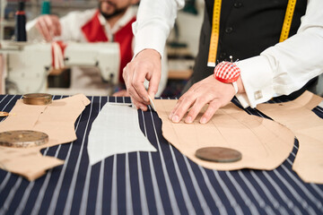 Professional tailor and his colleague in atelier