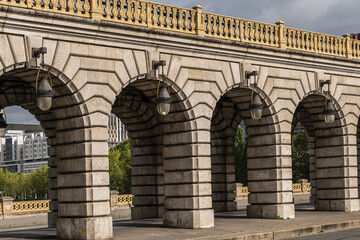 Obraz premium Bridge of Bercy (Pont de Bercy) is a bridge over the Seine in Paris. The Pont de Bercy, stone suspension bridge opened in 1864. Paris. France.
