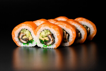 tasty Philadelphia sushi rolls with rice, salmon, , eel, cucumber, tobiko caviar, nori, Philadelphia cheese