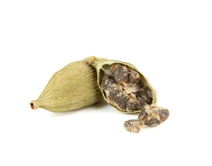 Close-up of green cardamom pods and seeds on a white background.