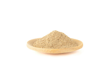 Ground cardamom powder on a mini wooden plate over a white background.