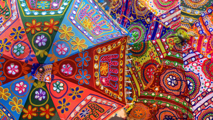 Handcrafted colorful umbrellas at display in a street market, Jaipur, India.