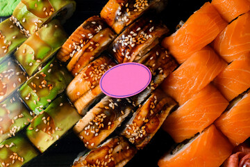 Close-up top view on appetizing Philadelphia and Green dragon sushi rolls.