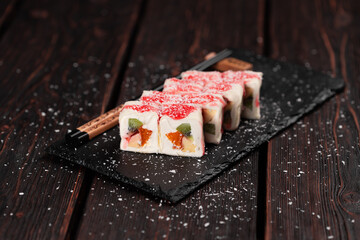 Asian sweet dessert maki sushi - Roll with fruits and cream cheese with coconut flakes and topping