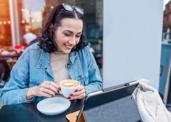 happy woman student e learning distance training course study working in cafe, drinking coffee,...