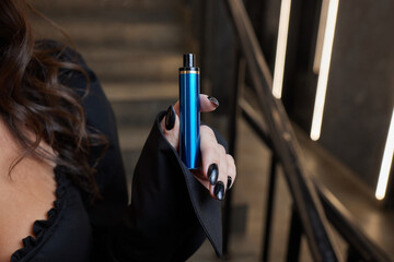 disposable electronic cigarettes in hand. The concept of modern smoking, vaping and nicotine.
