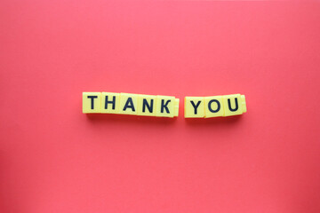 Thank you inscription in yellow letters on a red background.