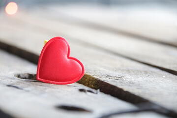 Fototapeta premium Red heart on a wooden background. Place for text. Valentine.