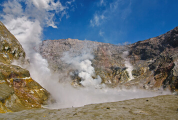 Lots of activity in the crater of Whakaari, White Island volcano in new Zealand with steam and boiling toxic water in the crater lake