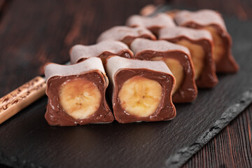 Asian dessert maki sushi - Roll with banana and chocolate cream close-up
