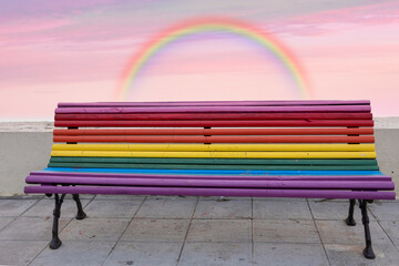 A bench in the street with the colors of the rainbow, symbol of the LGBT community, and an amazing...