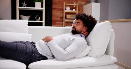 African American Man Relaxing On Sofa