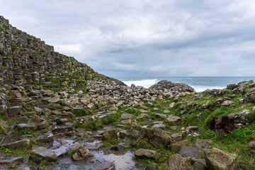 Fototapeta na wymiar Giant's Causeway, area of interlocking basalt columns in Northern Ireland. Result of an ancient volcanic fissure eruption. The Causeway Coast natural wonder is managed by the National Trust.