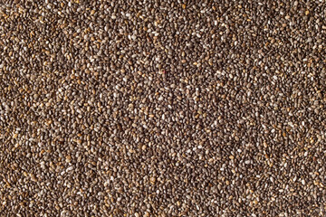 Top view of clean chia seeds close-up. Organic texture abstract background and superfood.