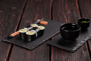 Maki sushi roll with cucumber and sesame with chopsticks. Sushi menu. Japanese food.