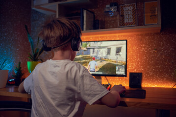 Boy playing shooter online video game - Technology trend concept 