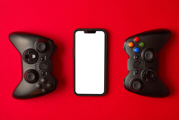 Modern black gamepad for smartphone on red background. Mobile video gaming device © stenkovlad