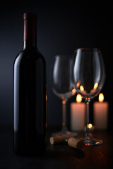 Glasses and bottle of wine on dark background