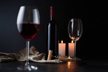 Glasses and bottle of wine on dark background