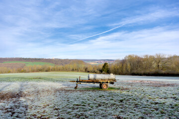 beautiful landscape in winter in germany with a water truck in the meadow