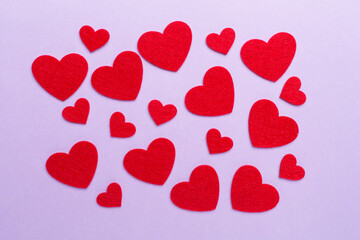 Felt hearts on color background, top view