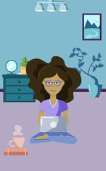 the girl is working on a laptop while sitting in the room