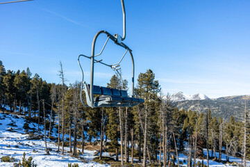 A chairlift on a mountain ski slope.