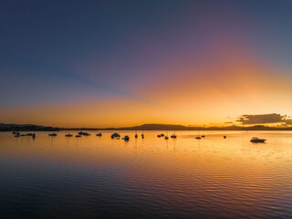 Obraz premium Aerial sunrise waterscape over the bay with boats