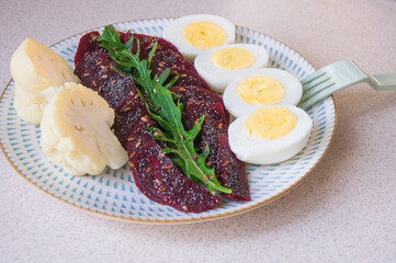 Breakfast, dinner, lunch is prepared from boiled beets, arugula, broccoli and boiled eggs