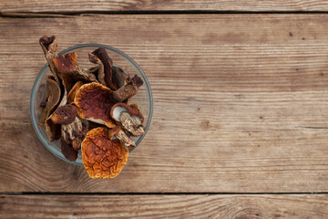 dried mushrooms in a glass bowl on the wooden table