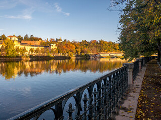 Colors of autumn Prague. Picturesque autumn colors on the embankment by the Vltava river, Prague,...