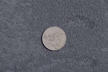 vintage rupiah coin of 50 with 1971 produced on dark background