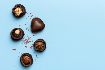 Different kinds of chocolates on colored table close-up. Top View and Flat Lay with copy space