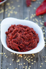 Traditional turkish chili pepper and tomato paste in bowl or spoon with dried peppers and fresh tomatoes on table