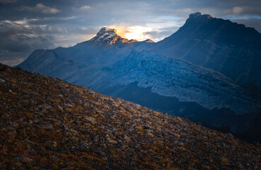 Light and storm clouds on mountain peak