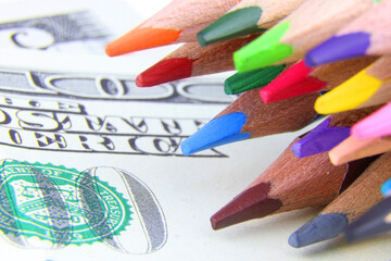 A set of color pencils and money.A School stuff.Drawing supplies