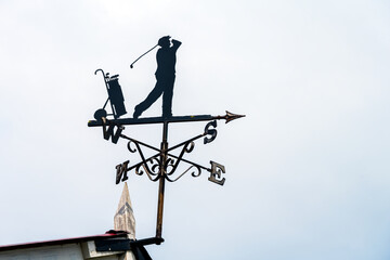 Silhouette of a weathervane representing a golfer, close up
