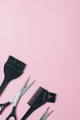Set of hairdresser tools on a pink background.